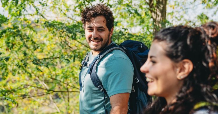 A young couple hike together in the park