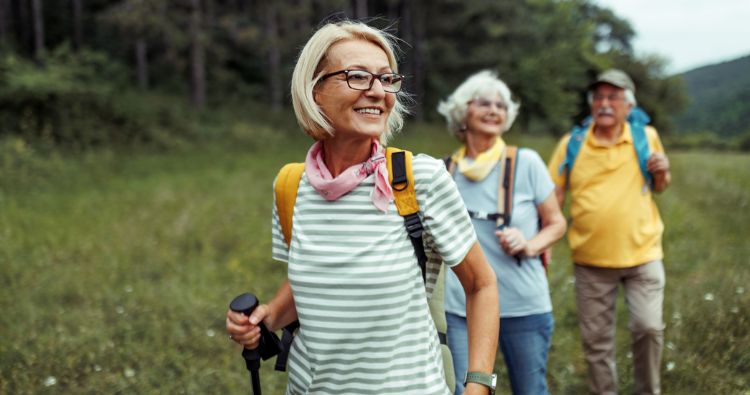 A group of retirees take a hike in the woods