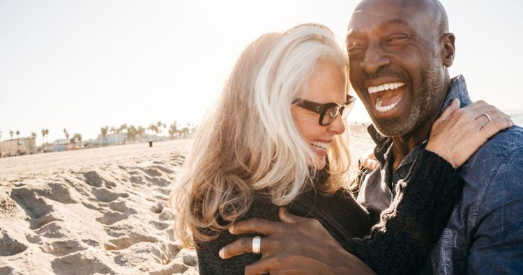 A retirement-aged couple enjoy a day at the beach